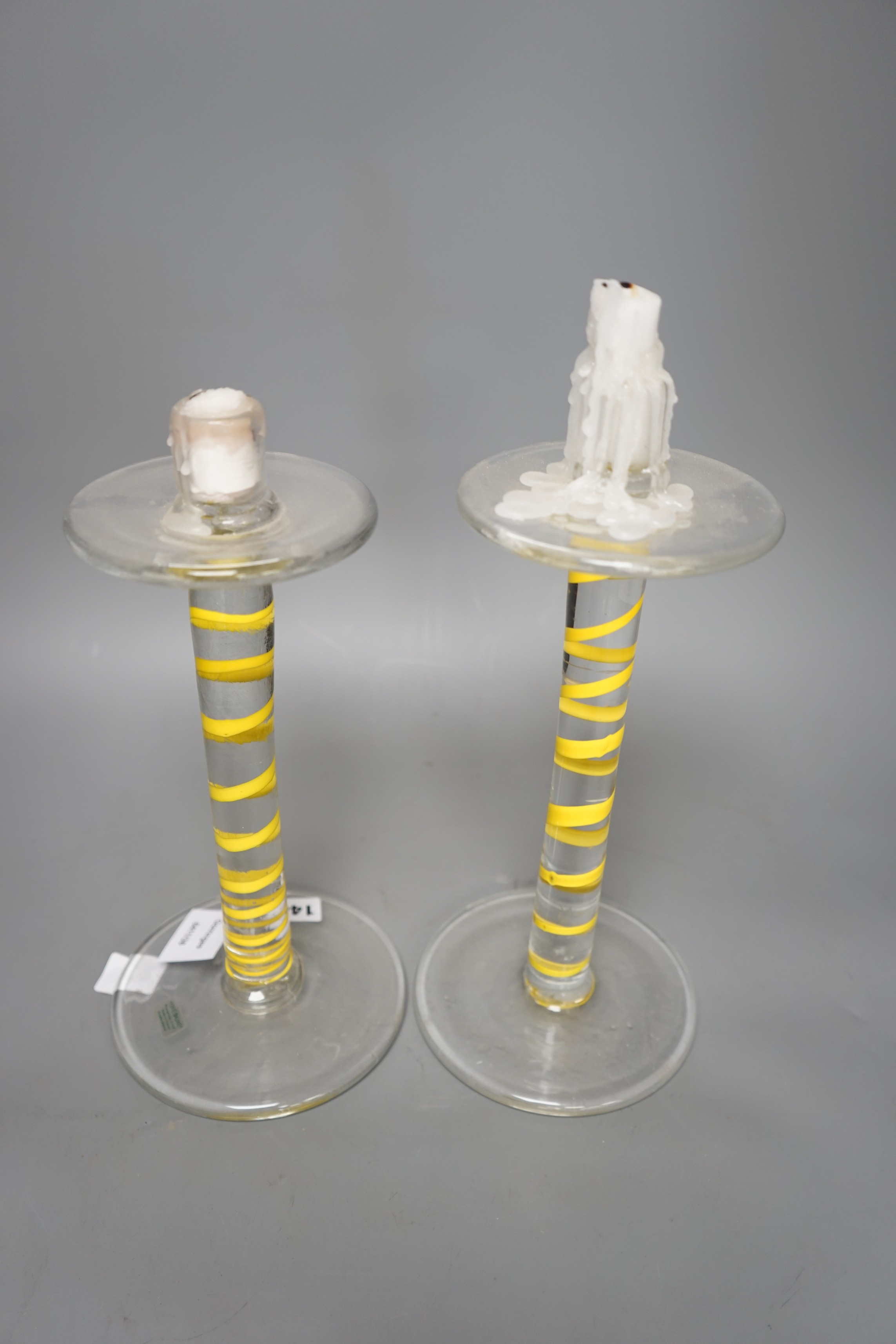 A pair of glass Herve Baume candle stands, 29cms high